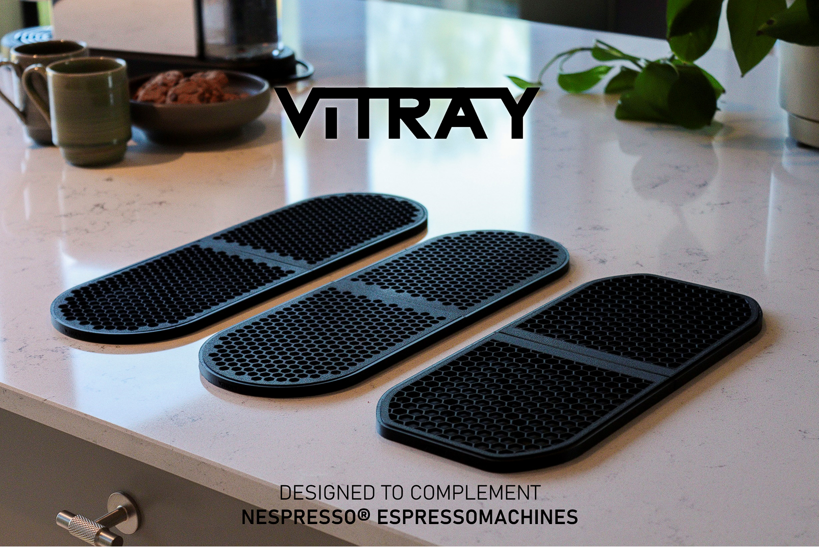 Three black Vitray 1, 2 &3 Nespresso machine accessory mats arranged on a white marble countertop, with the brand name Vitray displayed above and text at the bottom stating they are designed to complement Nespresso espresso machines.